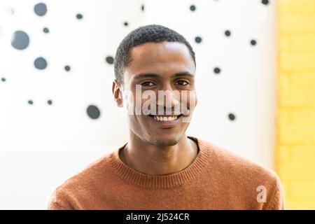 Portrait of happy middle eastern man looking at camera indoor - Handsome moroccan guy smiling at camera - Focus on face Stock Photo