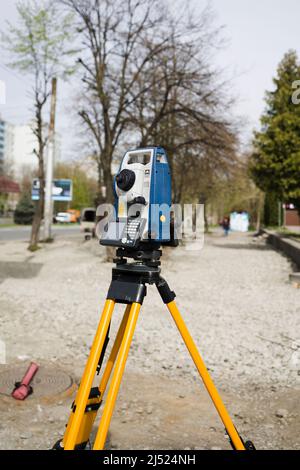 Vertical shot of  cheap geodesy level device on road Stock Photo