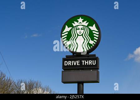 Swindon, England - April 2022: Tall sign at the Membury service station on the M4 motorway advertising a drive thru branch of Starbucks coffee. Stock Photo