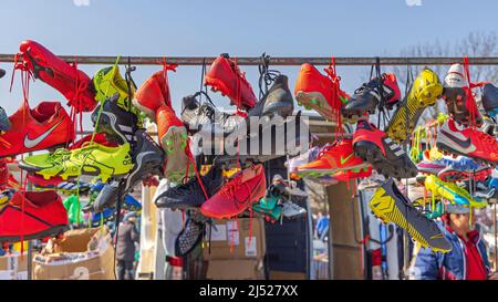 Belgrade, Serbia - March 26, 2022: Colourful Cleats Soccer Football Sports Shoes Hanging by Laces at Flea Market. Stock Photo