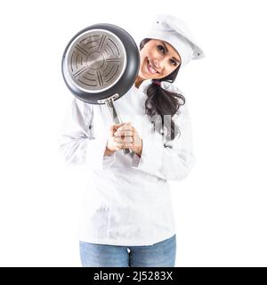 Chef brunette woman smiling from behind the pan - isolated on white. Stock Photo