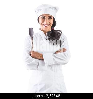 Female chef standing with a wooden scoop and crossed arms - Isolated on white. Stock Photo