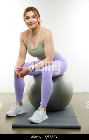 Athletic woman in fitness clothes or workout gear in studio Stock Photo