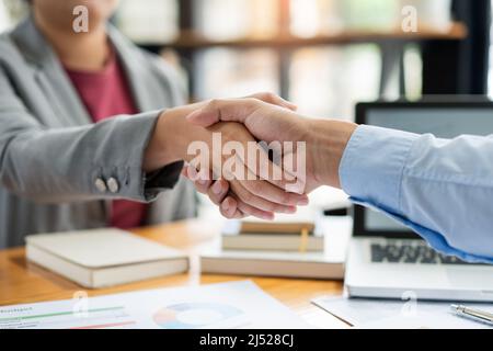 Business negotiation concept the estate representatives shaking hand each other to agree with the deal of land. Stock Photo