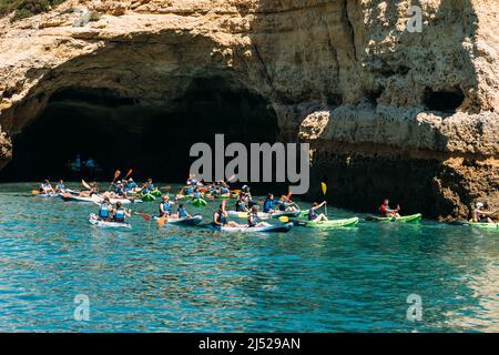 Benagil, Algarve, Portugal - April 15, 2022: Tourists on kayaks visit the Benagil cave in Benagil, Portugal Stock Photo