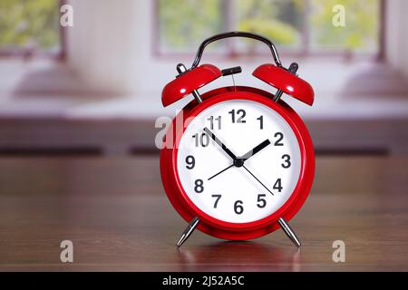 Red traditional alarm clock in room differential focus Stock Photo