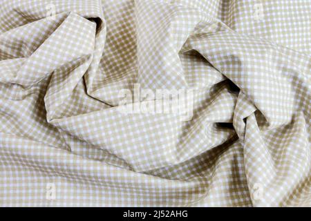 A beige and white, checkered sheet, wavy background. Graphic resources Stock Photo