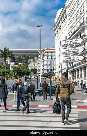 Downtown view on Algiers central post office and Aurassi hotel. Road sign direction of Bab El Oued, Martyr's square, Hotel Safir in Arabic and French. Stock Photo