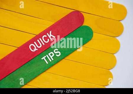 Quick tips text on red and green wooden stick. Stock Photo