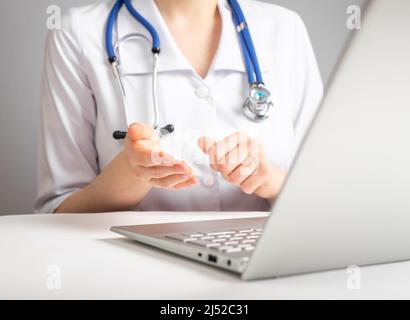Online medical consultation concept. Doctor with stethoscope speaking to patient through video chat. Telemedicine, telehealth concept. Medical information technology using. High quality photo Stock Photo