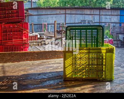 04 10 2022 Empty stacks of colorful plastic crates in a farmers produce market Pune Maharashtra India Stock Photo