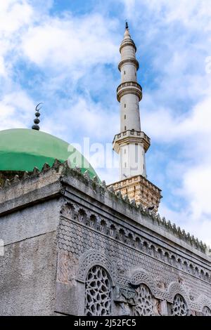 Dar El Arqam mosque in Chevaley, Algiers. Low angle view Masjid Al-Arqam outside part-of building view on minaret and green dome with cloudy blue sky. Stock Photo