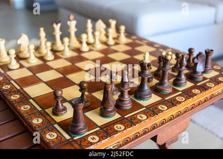 A wooden chessboard and chess pieces. Stock Photo