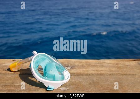 full face snorkel mask on wooden pontoon Stock Photo