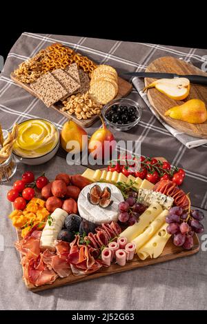 Cured cheese and meze platter setup rich in variety of fruits, cheese, meat and crackers Stock Photo