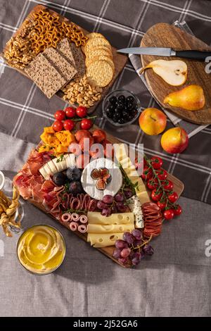 Cured cheese and meze platter setup rich in variety of fruits, cheese, meat and crackers Stock Photo