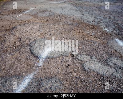 Pothole in British road, major problem for car damage, accidents and insurance claims Stock Photo