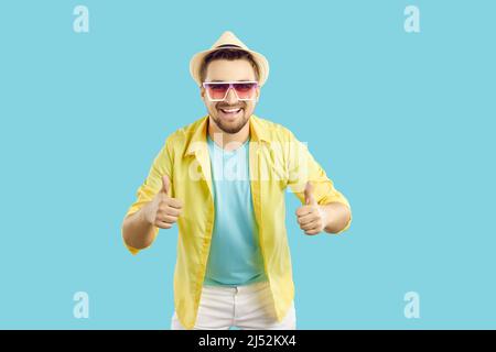 Happy man who is satisfied with his summer holiday smiling and showing thumbs up Stock Photo