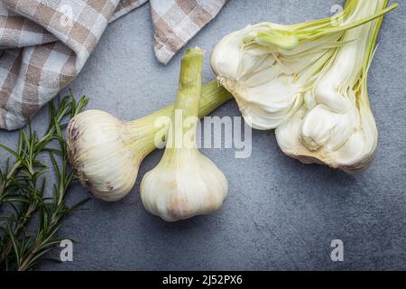 Whole garlic bulb. Fresh white garlic on a kitchen table. Top view. Stock Photo