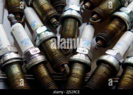 Old spark plugs taken out of a six cylinder engine after 100,000miles Stock Photo