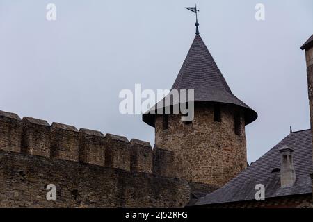 Photo of a medieval castle in the city of Khotyn, Ukraine. Stone walls with battlements, a turret with loopholes are well preserved. Stock Photo