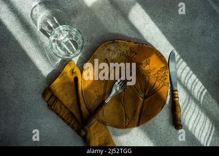 Overhead view of a minimalistic rustic place setting on a table Stock Photo