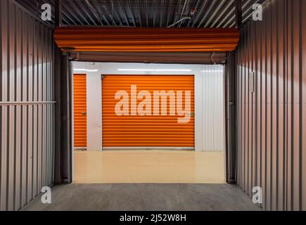 Empty self storage unit as seen from inside looking out Stock Photo