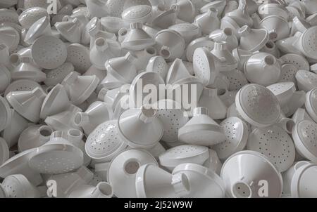 Large pile of plastic watering can pieces in manufacturing facility Stock Photo
