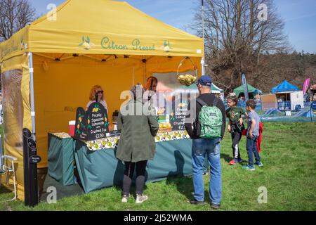 Family buying freshly squeezed lemonade from the Citron Presse catering stand as the Henham Easter Country Show, April 2022 Stock Photo