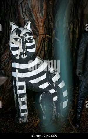 Folk art cat, garden black and white striped cat ornament, Stock Photo