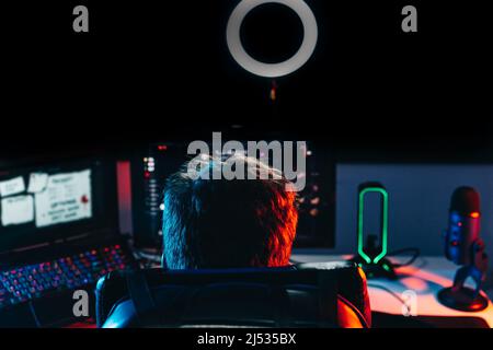 young male professional online video game streamer, playing on computer. Close-up of a gamer set-up Stock Photo