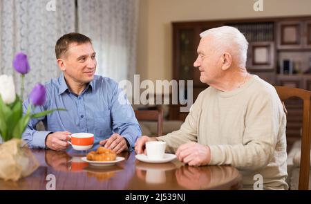 Man and his adult son drinking tea Stock Photo