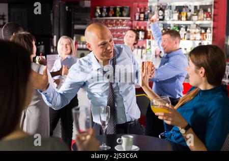 Male and female having fun on corporate party Stock Photo