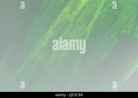 Caustic effect light refraction on green wall overlay photo mockup, blurred sun rays refracting through glass prism with shadow. Abstract natural Stock Photo