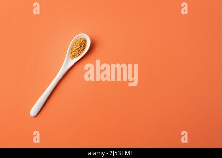 Organic amaranth seeds in ceramic spoon - Amaranthus Stock Photo