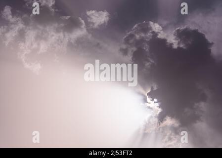 Black and white of sky with clouds and sunbeams Stock Photo