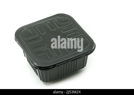 Isolated black plastic box or container for food on white background, cube shape food box with lid, 45-degree angle view. Blank space for brand label Stock Photo