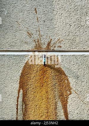 A copper pipe and rust on a concrete wall Stock Photo