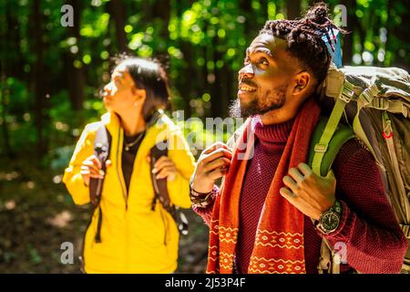 latin american man and hispanic woman in a forest having a rest . Stock Photo