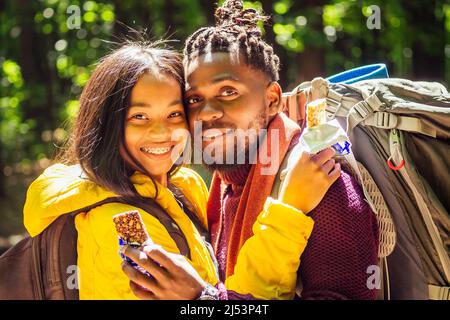 latin american man and hispanic woman in a forest having a rest . Stock Photo