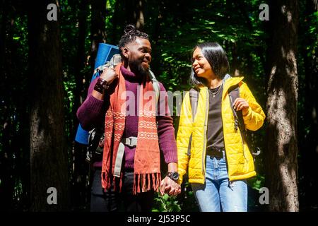 latin american man and hispanic woman in a forest having a rest . Stock Photo