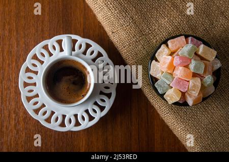 Traditional Turkish delight and Turkish coffee on a wooden background,top view Stock Photo