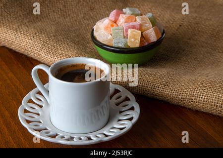 Colorful Turkish delight and Turkish coffee on a wooden background Stock Photo