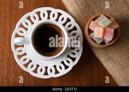 Traditional Turkish delight and Turkish coffee on a wooden background,top view Stock Photo