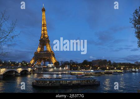 Paris, France: The Eiffel Tower, metal tower completed in 1889 for the Universal Exposition, seen at night illuminated from the bridge Pont d’Iéna Stock Photo