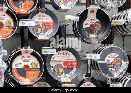 Tyumen, Russia-April 14, 2021: Tefal frying pan display in a large hypermarket. Sale of kitchen utensils Stock Photo