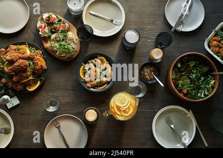 High angle view of dining table served with various dish and appetizers for party dinner Stock Photo