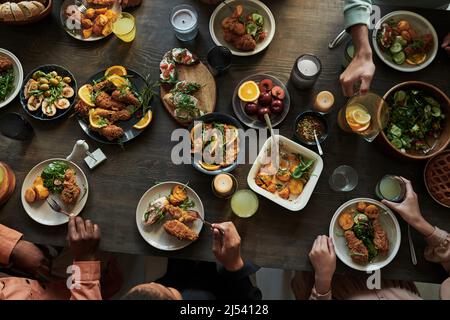 High angle view of group of people sitting at dining table and having holiday dinner Stock Photo