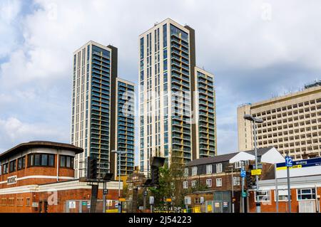 The recently completed mixed use tall tower block development at Victoria Square, Woking town centre, Surrey, seen from Woking station with signal box Stock Photo