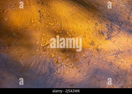 yellow sand is visible through the clear water of the river in the sun Stock Photo